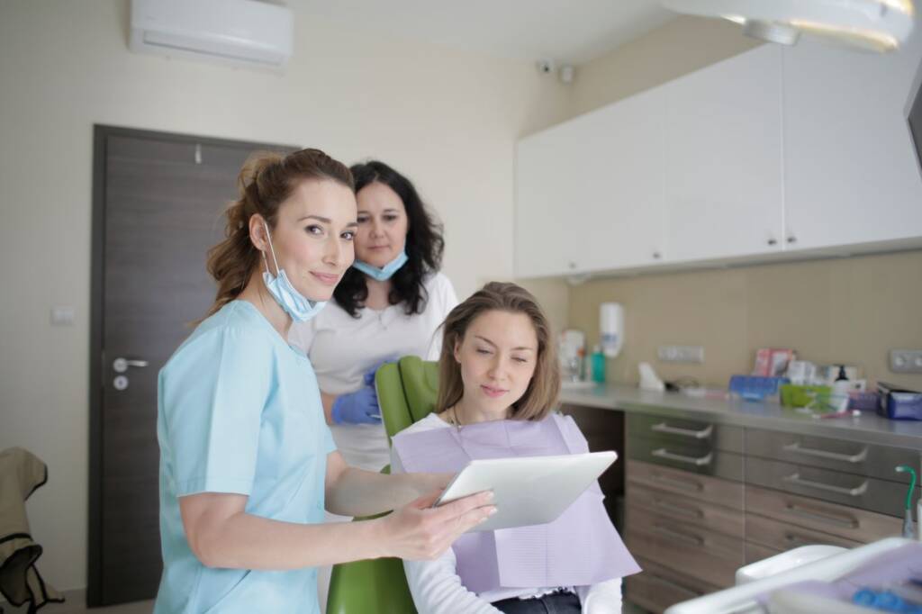 Dental team reviewing insurance coverage information with a patient in Atlanta, GA